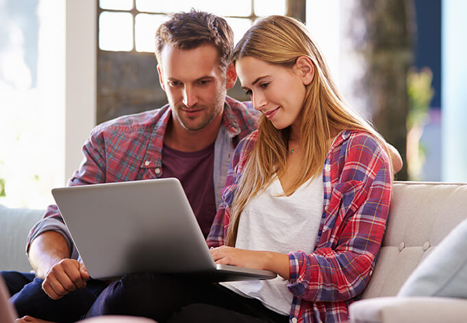 Happy Couple Watching Laptop